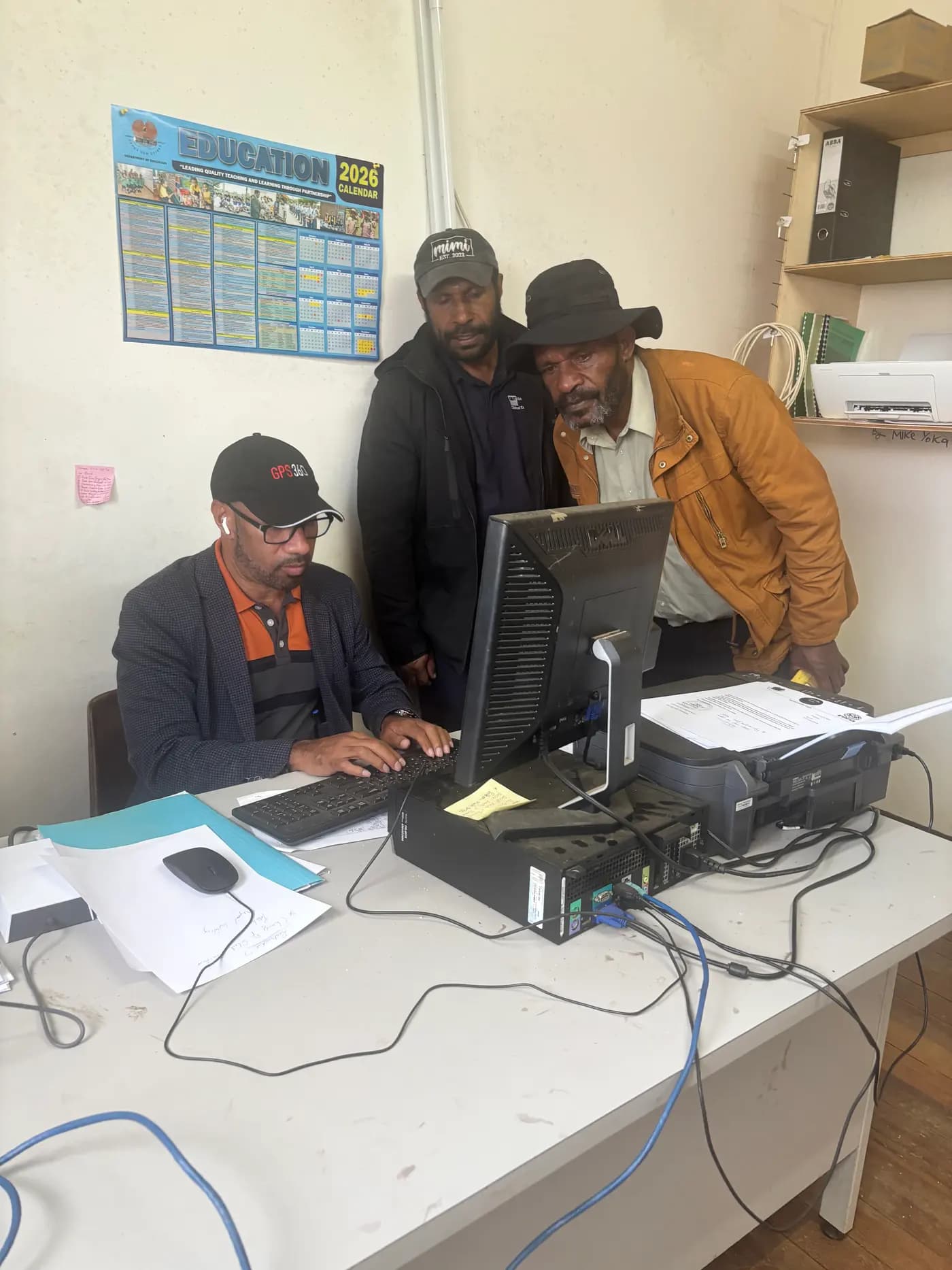 GPS360 staff delivering computer training to teachers at Iombi Schools in the Southern Highlands